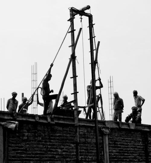 free-photo-of-captured-in-striking-black-and-white-this-portrait-features-determined-mens-on-a-construction-site-rooftop-ropes-in-hand-embodying-strength-and-purpose-amidst-urban-landscapes